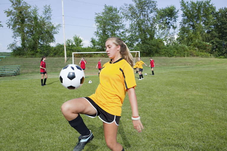 Girl practicing soccer skills